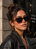 Model wearing Betty’s Retro Shades Beatrice sunglasses in clear brown