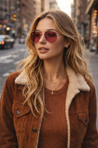 Model wearing Betty’s Retro Shades Cherry sunglasses in gold