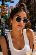 Model wearing Betty’s Retro Shades Elise sunglasses in marbled blue