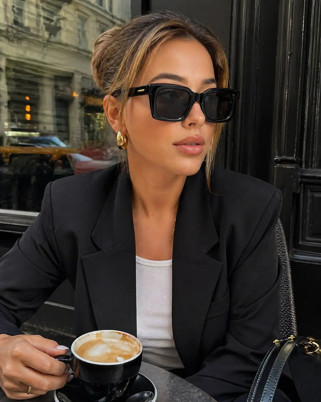 Model wearing Betty’s Retro Shades Frankie sunglasses in black
