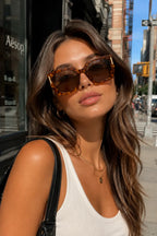 Model wearing Betty’s Retro Shades Magnolia sunglasses in tortoiseshell