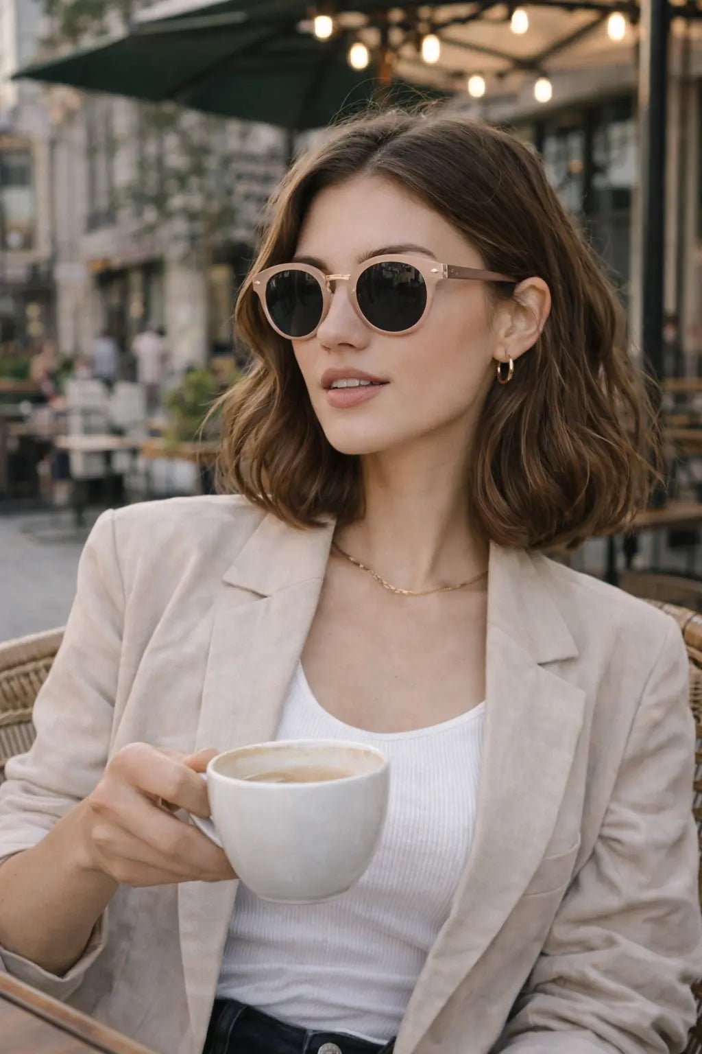 Model wearing Betty’s Retro Shades Opal sunglasses in amber