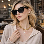 Model wearing Betty’s Retro Shades Stella sunglasses in black