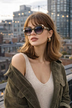Model wearing Betty’s Retro Shades Sylvia sunglasses in marbled green